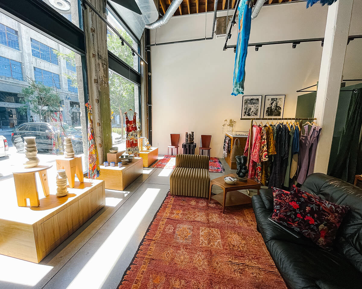 BEL KAZAN store has windows facing the street, BEL KAZAN ethical clothing, and couch.